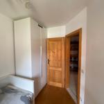 Bedroom with bed, wardrobe, and door to hallway.