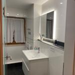 Bathroom with sink, mirror, and shower.