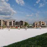 Moderne Wohnhäuser mit großzügigen Balkonen und gepflastertem Platz vorne.