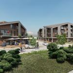 Moderne Wohnhäuser mit Balkonen und Außenbereich mit Sitzgelegenheiten.