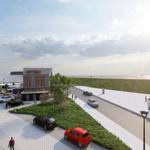 Modernes Haus mit Blick aufs Meer und gepflasterte Straßen mit parkenden Autos.