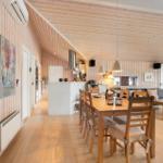 Living area with dining and kitchen under wooden ceiling