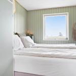 Bedroom with bed, window, and wall decoration.