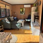 Living room with sofa, coffee table, and TV mounted on the wall.