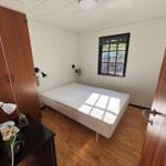 Bedroom with bed, wardrobe, and window