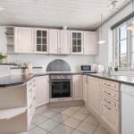Kitchen with light cabinets, dark countertop, and window