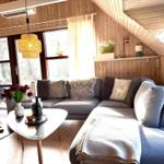 Wohnzimmer mit Sofa, Couchtisch und Holzwand