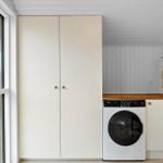 Laundry room with washing machine, closet, and window