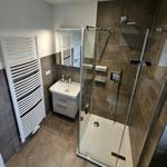 Bad mit Dusche, Waschbecken und Heizkörper