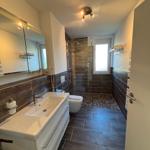 Bathroom with shower, sink, and toilet