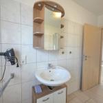 Bathroom with sink, mirror cabinet, and towel holder.