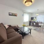 Living and dining area with sofa, table, and chairs.