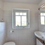 Bathroom with window, sink, and mirror cabinet
