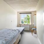 Bedroom with double bed, window, and wardrobe.