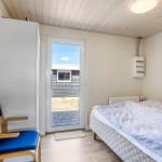 Bedroom with bed, chair, and door to outdoor area.