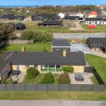 Modern house with garden, terrace, and sea view.