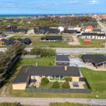 Modern vacation home with large garden and coastal view.