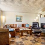 Living room with sofa, armchair, and fireplace