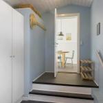 Entrance with closet, steps, and view into dining room.