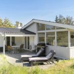 House with terrace, sun loungers, and outdoor grill.