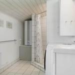 Bathroom with shower, sink, and heater.