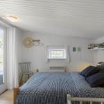 Bedroom with bed, window, and door to balcony.