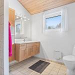 Bathroom with sink, toilet, and window