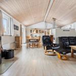 Living and dining area with fireplace, sofa, and dining table.