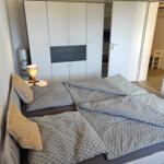 Schlafzimmer mit Doppelbett, Kleiderschrank und Nachttisch.