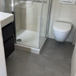 Badezimmer mit Dusche, Toilette und Waschbecken