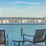Balkon mit Sitzgelegenheiten und Blick auf Wasser und Häuser