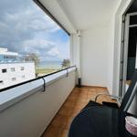 Balcony with table and chair. View of beach and sea.