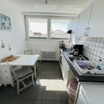 Kitchen with dining table, window, and sink