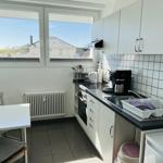 Kitchen with window, worktop, sink, and stove.