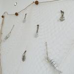 Wand mit Fischerdekoration aus Netz und Ankeranhängern.