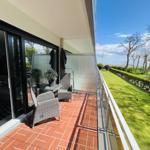 Terrace with seating and view of green lawn.