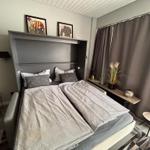 Bedroom with bed, window, and decorative items.