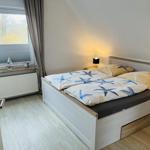Bedroom with bed, nightstand, and window view.