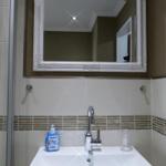 Bathroom with sink, mirror, and shower