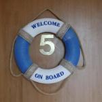 Welcome sign with number 5 on door