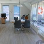 Dining room with table, chairs, and glass doors to terrace.