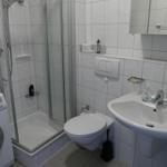 Bathroom with shower, toilet, and sink.