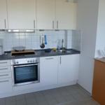 Kitchen with white cabinets, stainless steel stove, and countertop