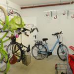 Storage area with multiple bicycles and hooks for outdoor equipment.