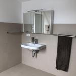 Bathroom with sink, mirror cabinet, and towel rack.