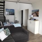 Living and dining area with sofa, table, and wall art.