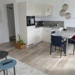 Kitchen with dining table, white cabinets, and wooden floor