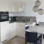 Modern kitchen with dining area and built-in oven.