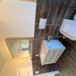 Bathroom with toilet, sink, and mirror