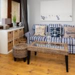 Living room with sofa, wicker storage and wooden floor